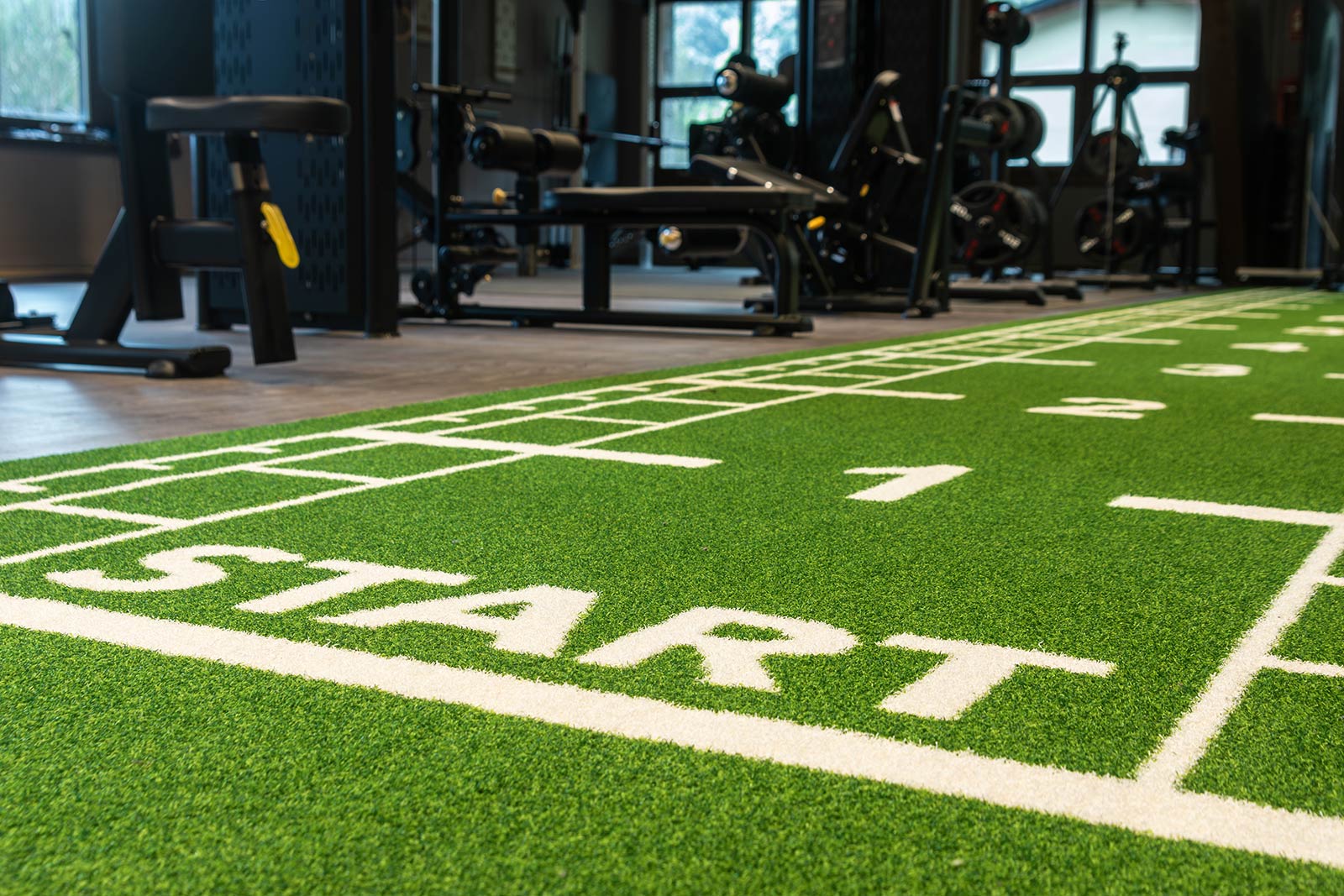 Closeup of green football turf inside gym